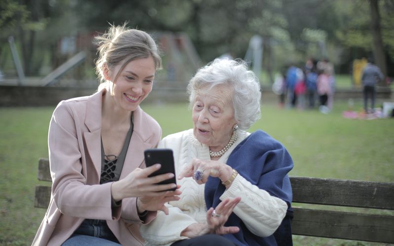 Adult daughter helping elderly mother set up a mobile phone — C1+ 4G setup guide